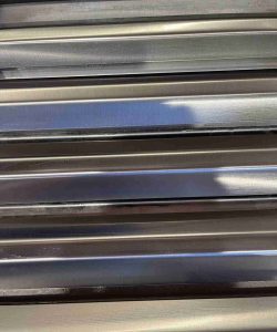 Close-up of several parallel metal or steel bars reflecting light.